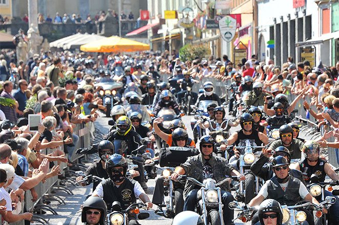 crowd watching motorcycle parade
