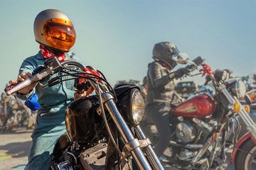 motorcyclist on bike with other riders in background
