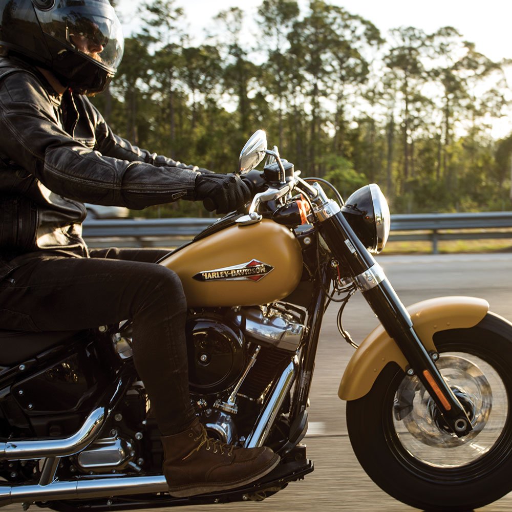 Man riding a yellow motorcycle